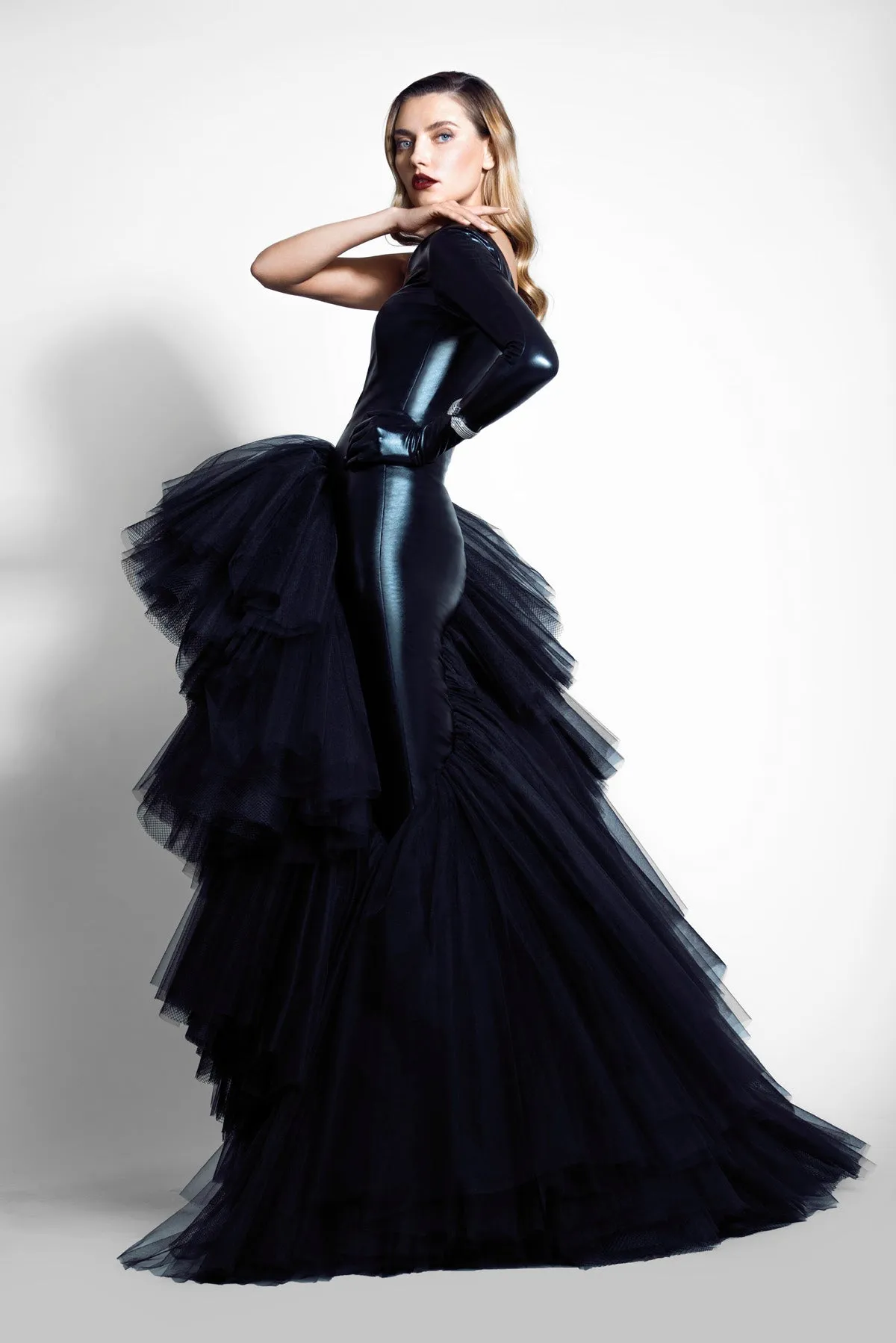 Slinky black latex gown with built-in glove, embroidered bustier, and a breakout skirt in layered tulle and structured netting